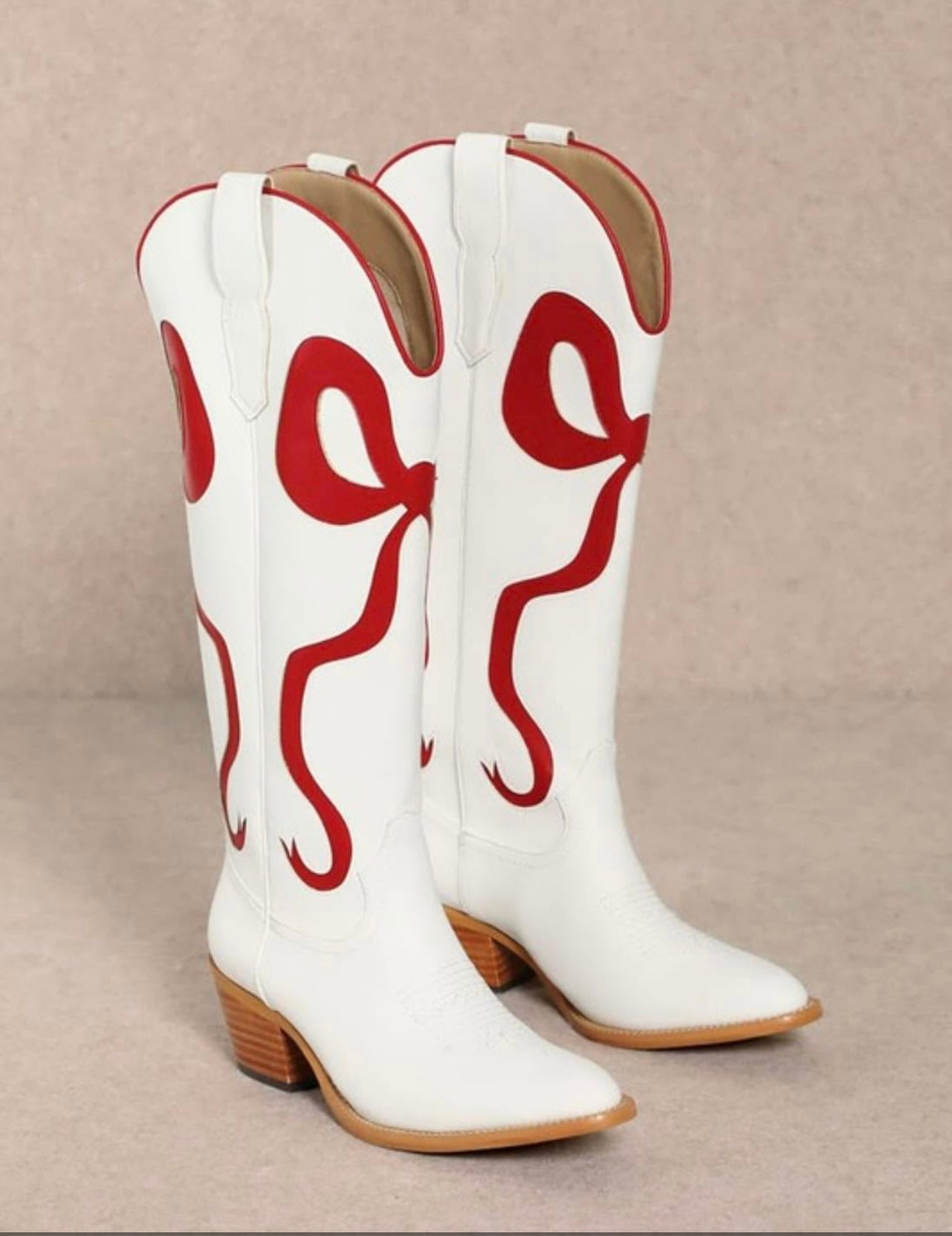 White western leather boots with red bow detail